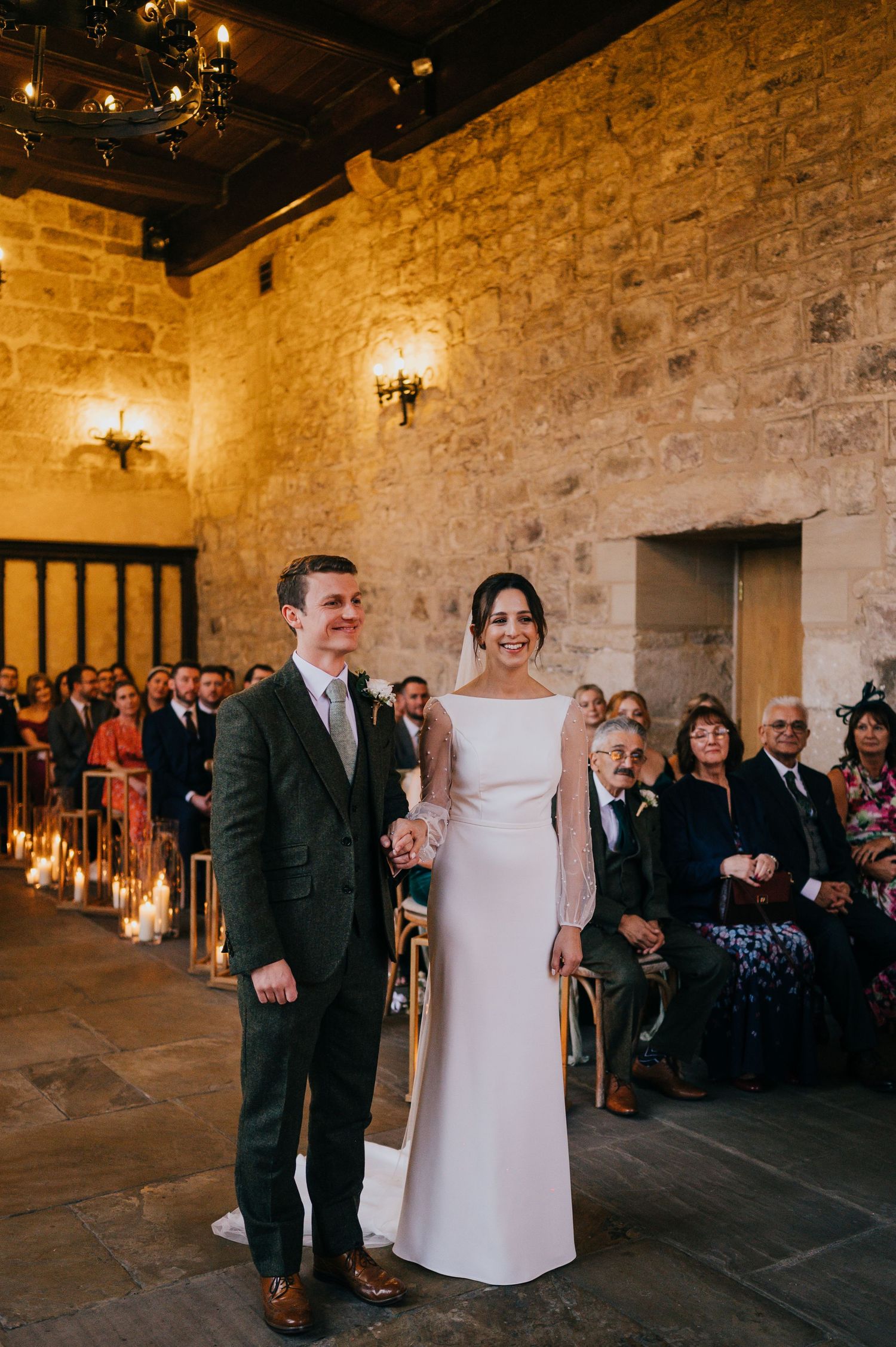 A romantic sunset wedding portrait in a rustic outdoor setting with golden light.