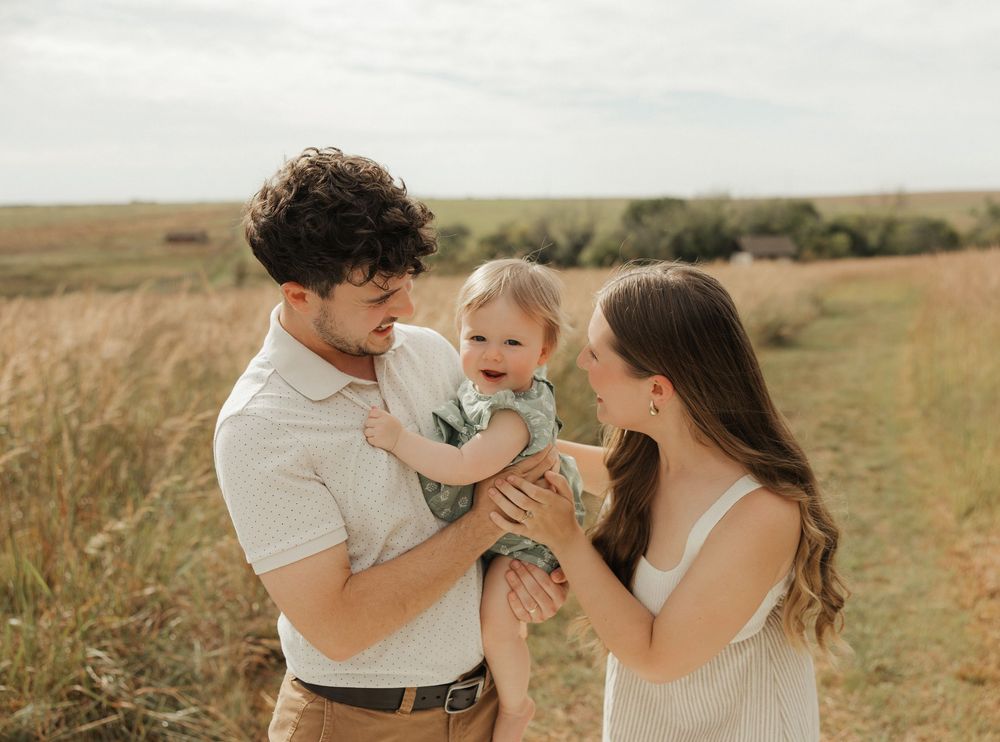 A series of romantic outdoor photos showing tender moments between a couple in a rustic field setting at sunset.