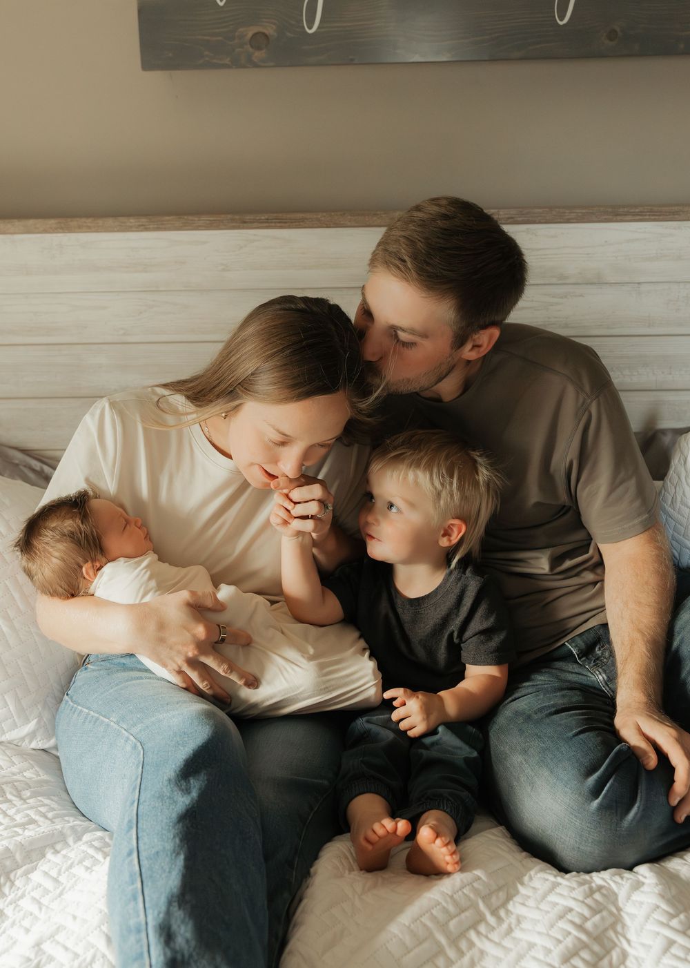 A family cuddles together on a cozy bed while sharing tender moments in a series of connected photos.
