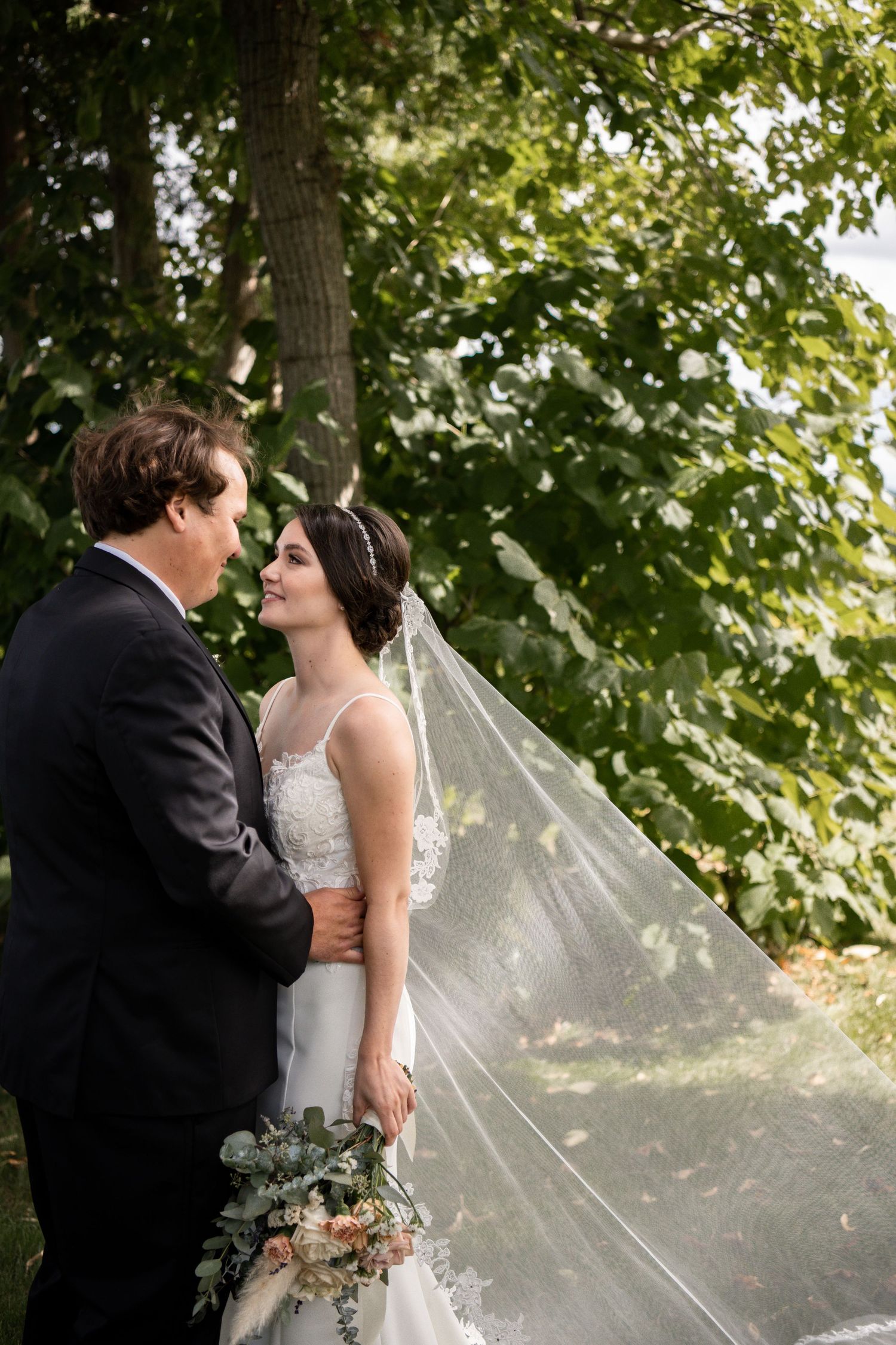 A married couple sharing a kiss in-front of a lake