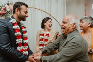 Wedding celebration with traditional flower garlands and joyful family gathering.