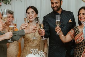 Wedding celebration toast with champagne glasses and formal attire.