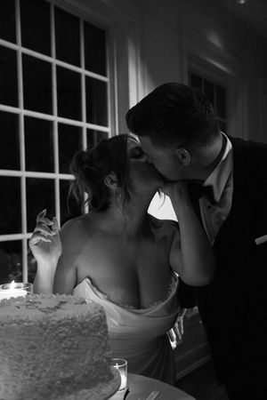 Intimate candlelit moment between newlyweds during wedding reception.