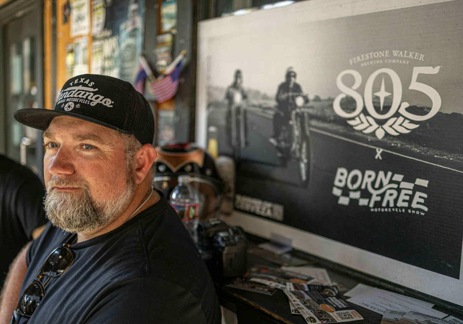 Retail display showing motorcycle lifestyle merchandise and vintage photos.