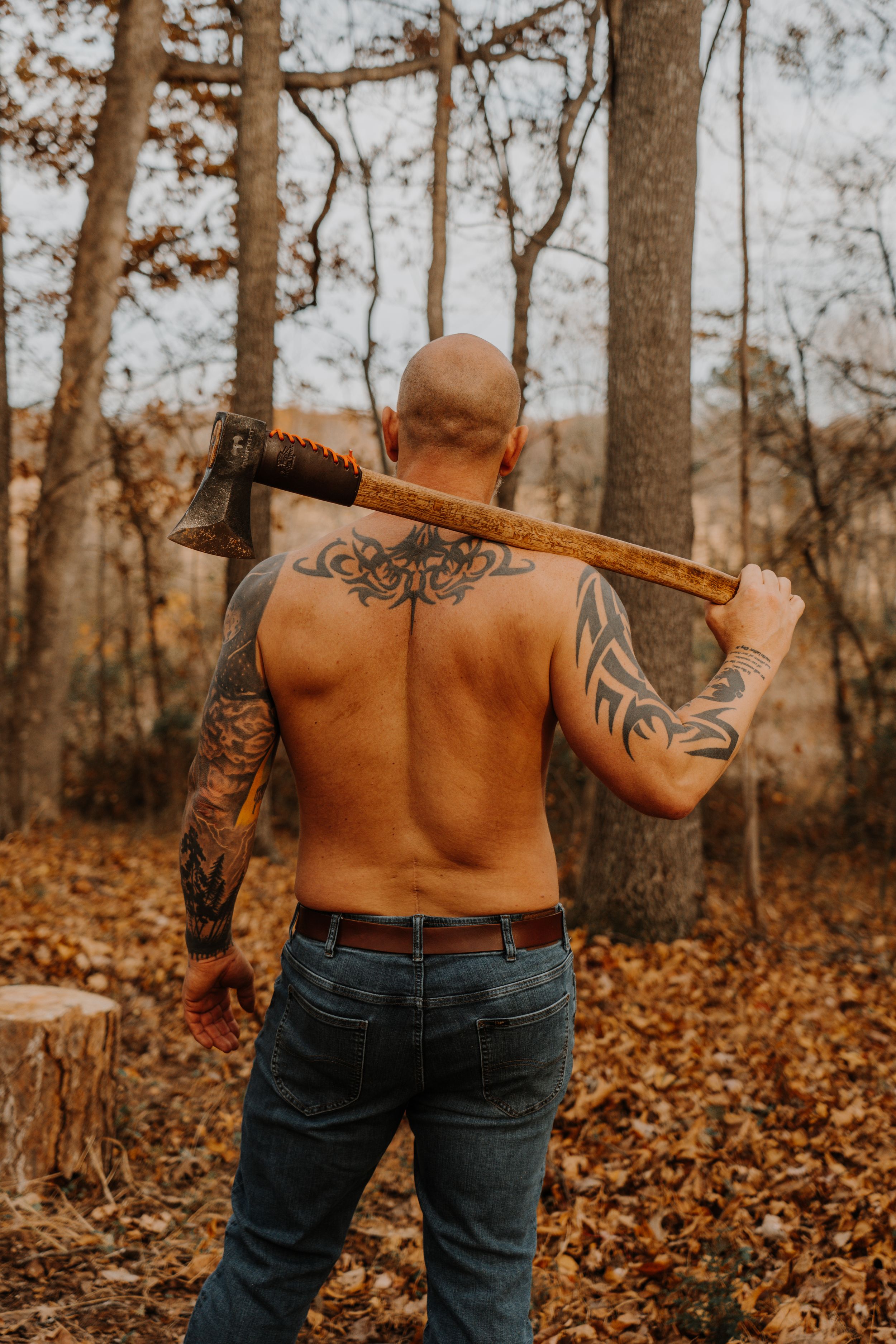 Multiple views of a shirtless person with back tattoos standing among autumn trees in warm lighting.