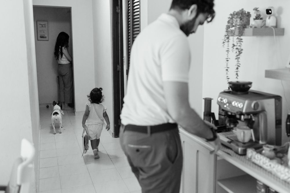 Black and white scene of daily life in a home kitchen with coffee maker.