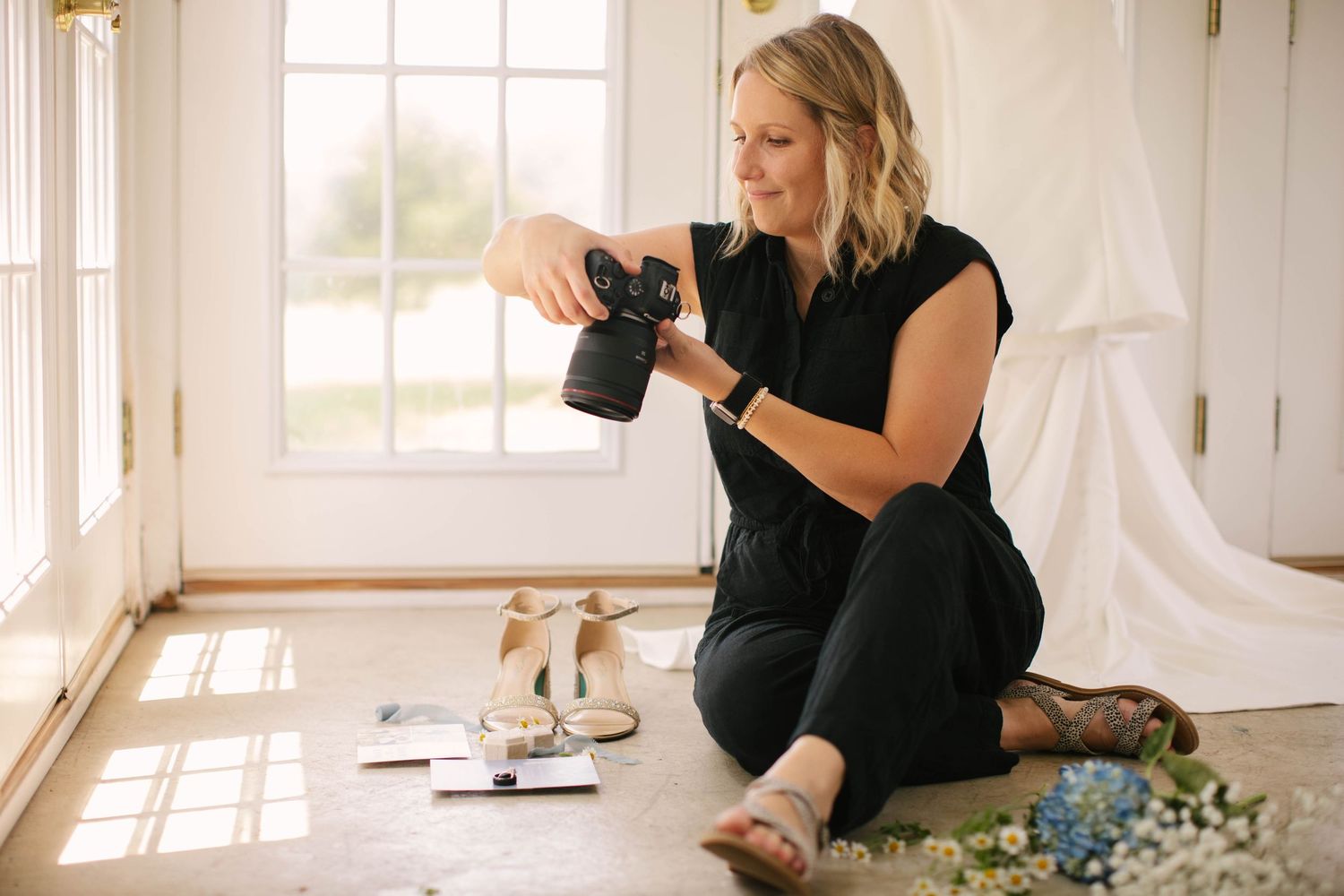 Side view of photographer taking pictures with professional camera at event.