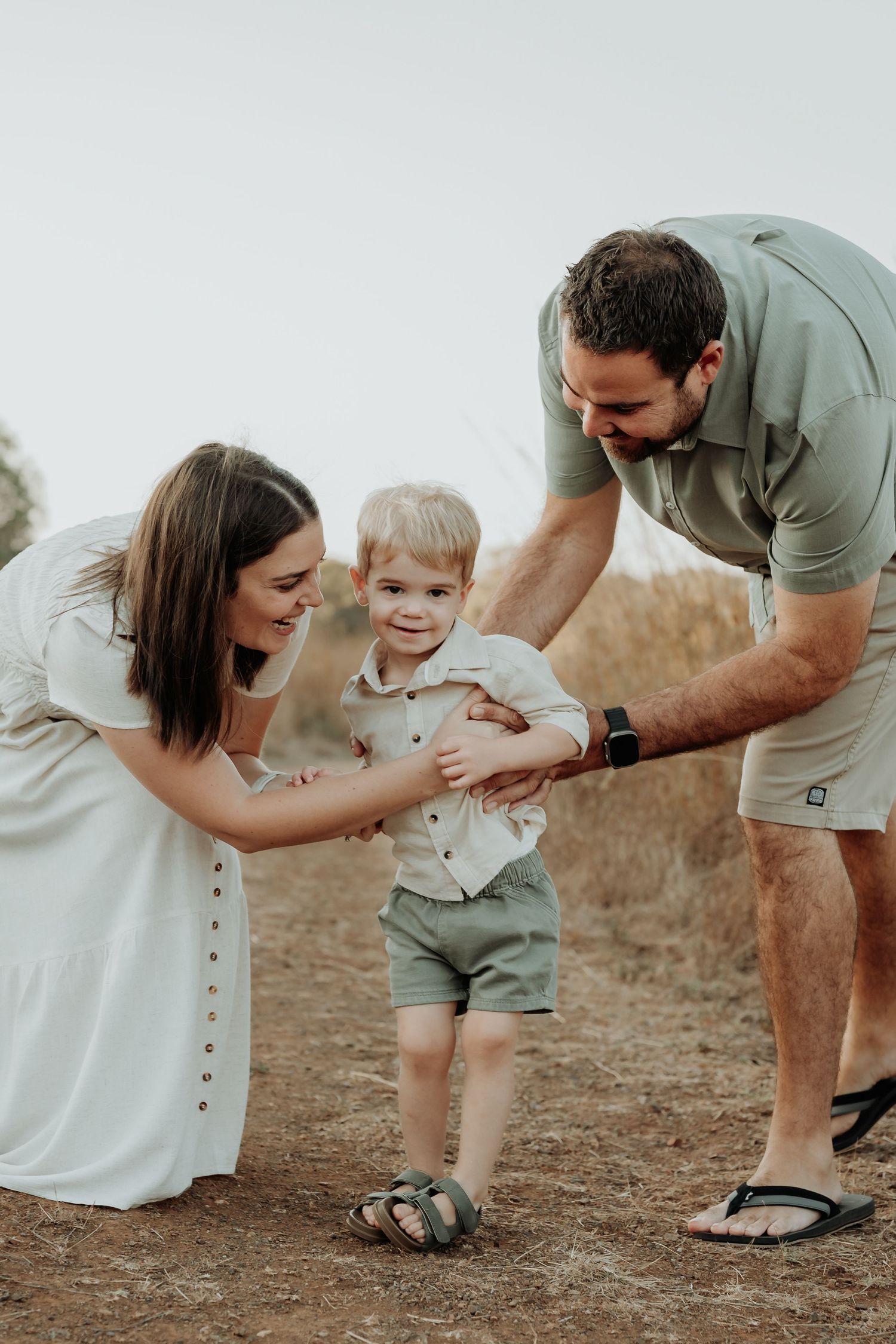 family looking at each other and laughing in calliope field