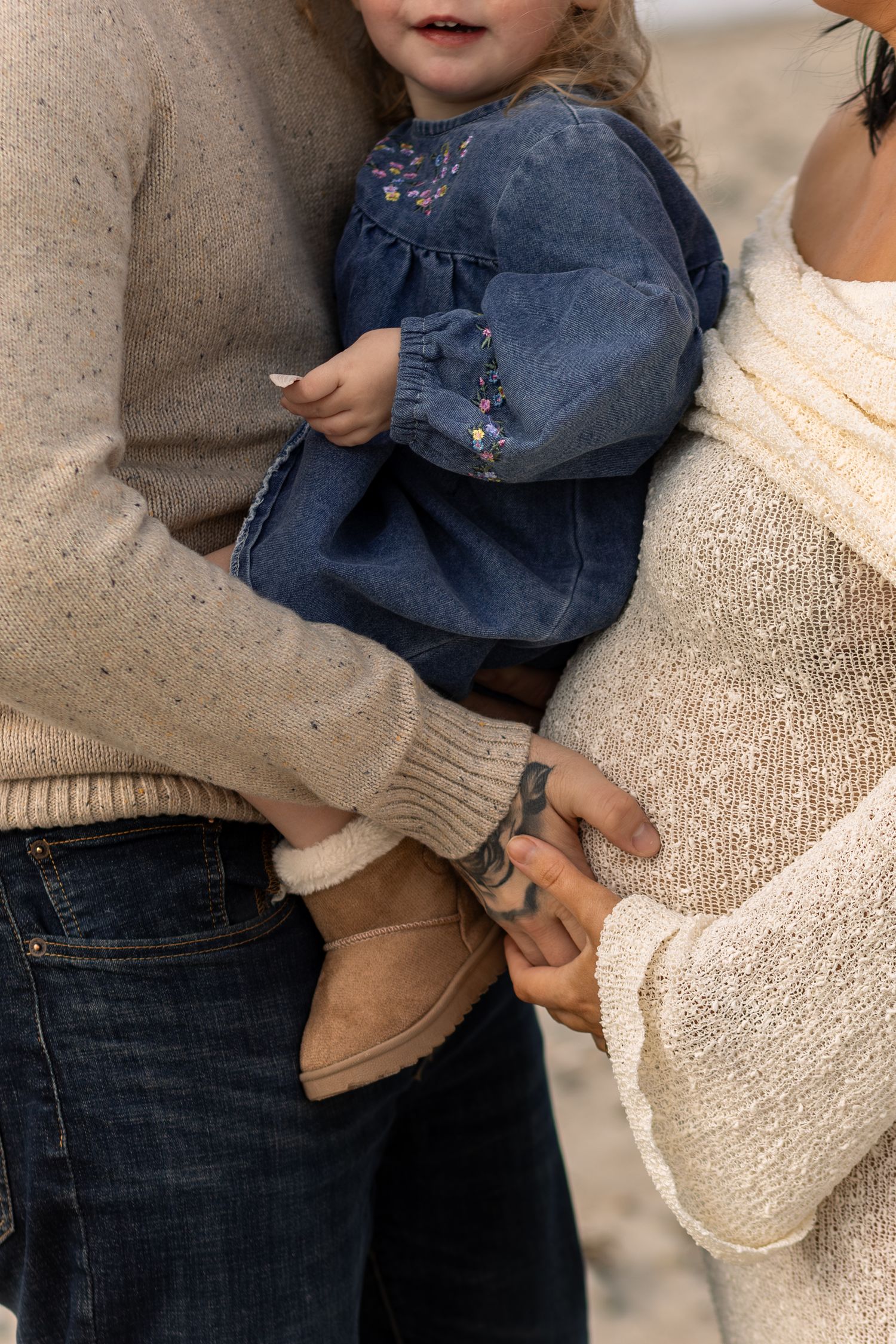Close-up portrait photography of a pregnant couple with their daughter in Massachusetts.