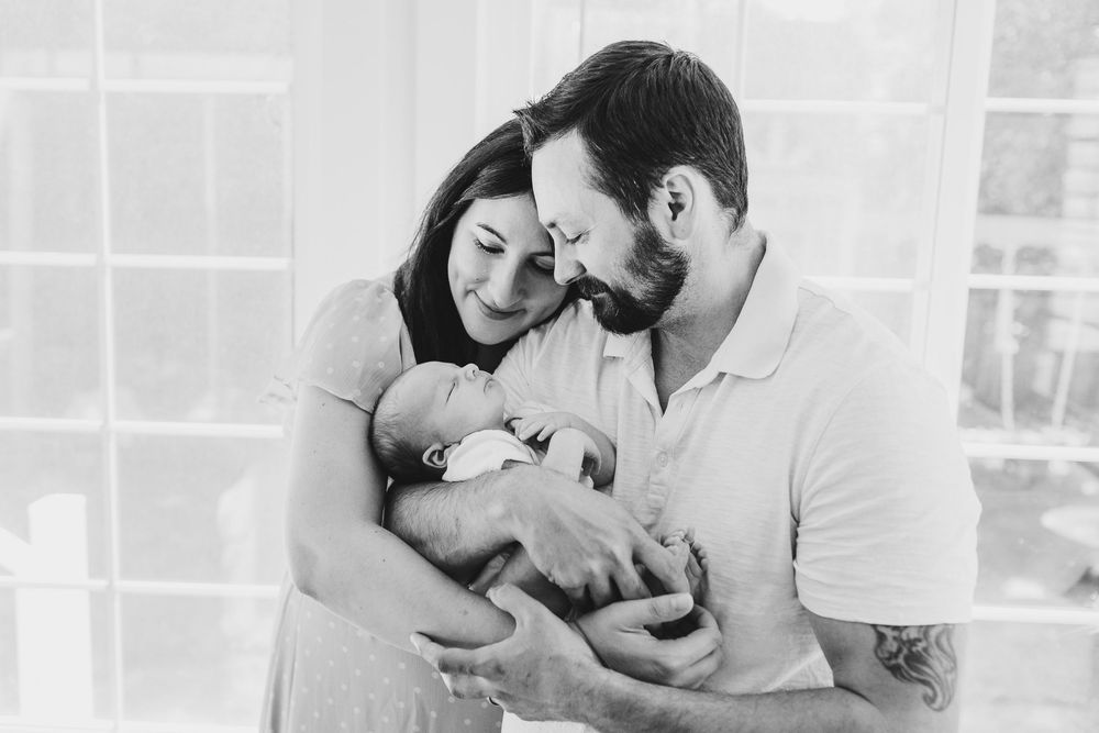A series of romantic black and white photographs showing tender moments between a couple in intimate poses.
