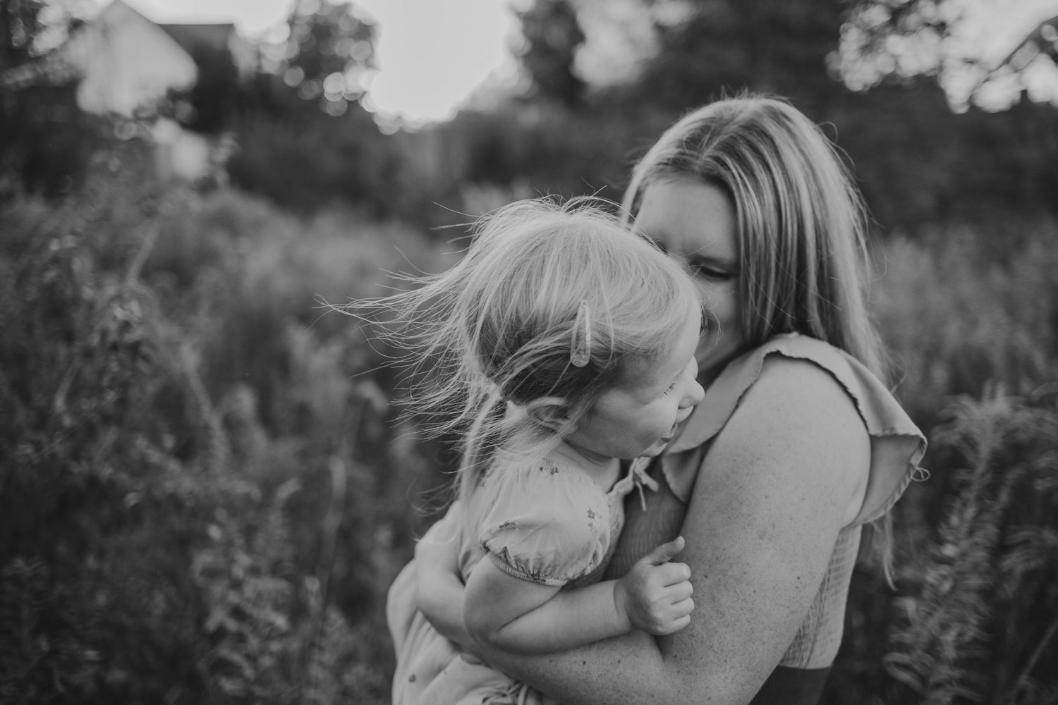 Emotional motion, black-and-white mommy and daughter playing during a family session and Zionsville, Indiana