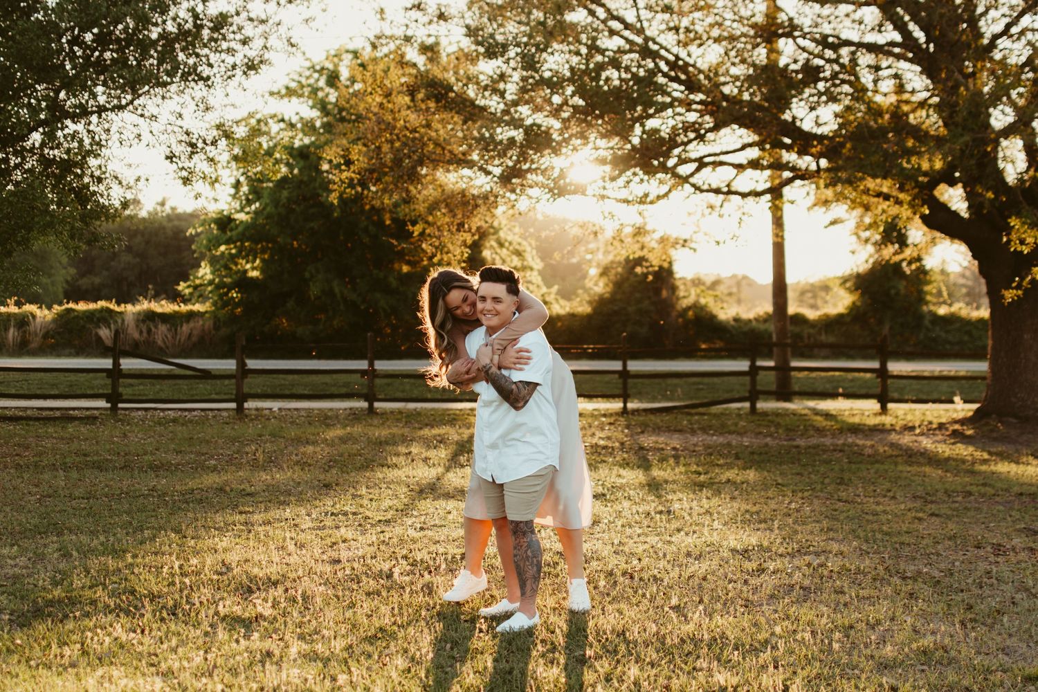 Family enjoys golden hour moments in a grassy field with sunset backdrop.