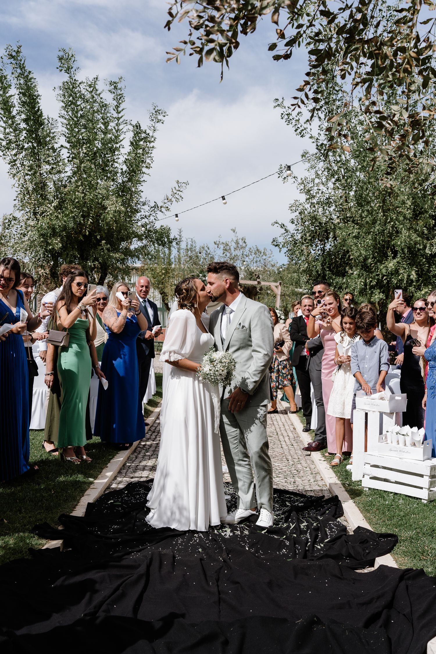 A dramatic black and white photo series featuring a bride in a flowing white dress against architectural elements.
