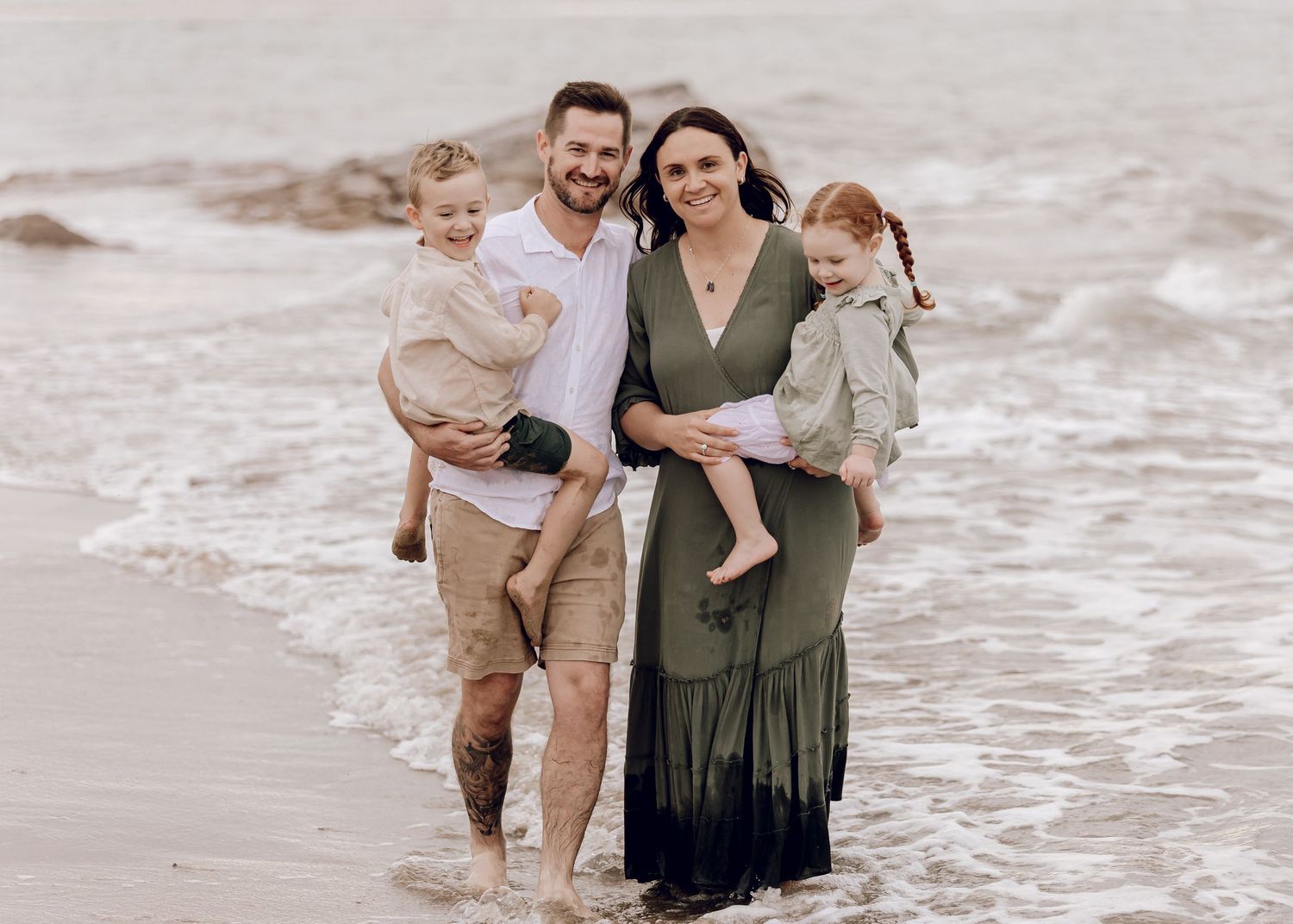 A family enjoys a peaceful sunset moment together. Professional family photographer, Townsville, QLD, Australia