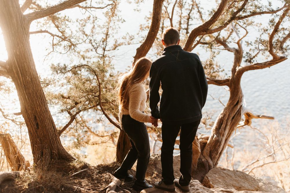 A couple walking towards a gnarly tree overlooking the Mississippi River near Schaar’s Bluff Gathering Center in Hastings, Minnesota.