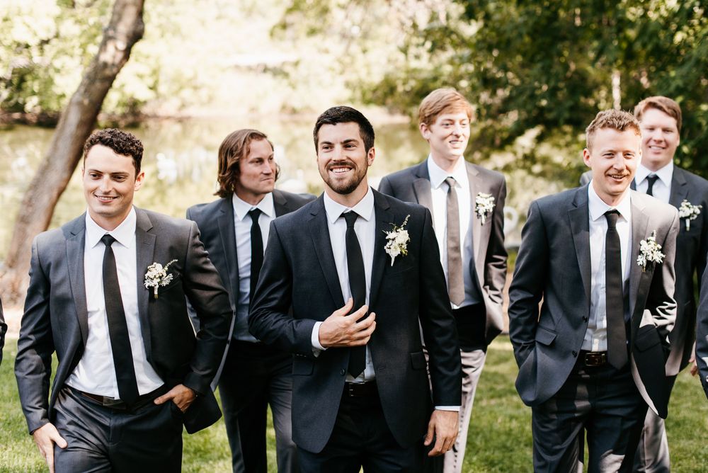 A groom and his groomsmen walking towards the camera, laughing at the Charleston Event Center in White Bear Lake. Lindsay Miller Photography