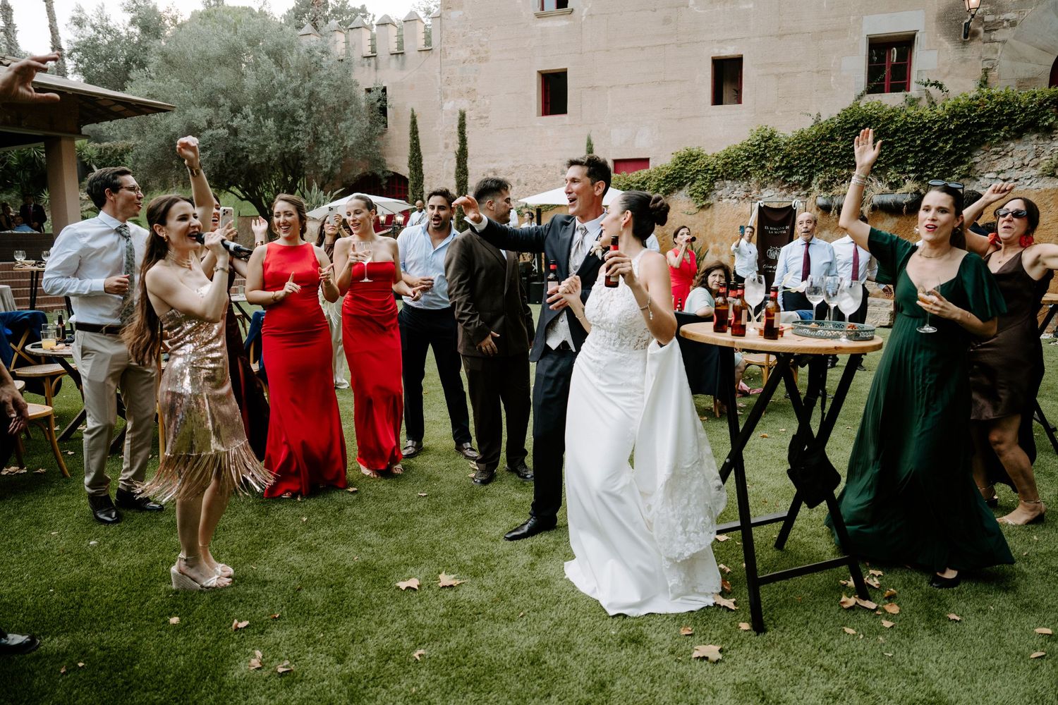 Bride and groom toasting with guests during an elegant outdoor wedding reception celebration.