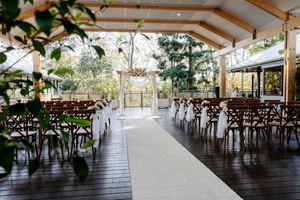 Covered outdoor ceremony on The Deck at Walkabout Creek, rain-safe wedding venue