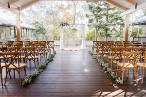 Covered outdoor ceremony on The Deck at Walkabout Creek, rain-safe wedding venue