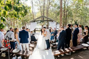 Wedding ceremony at Walkabout Creek, Brisbane rainforest lakeside wedding venue