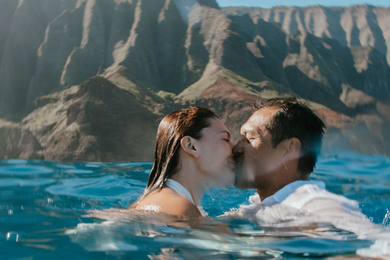 Wedding Elopement Bridal Portraits of a bride and groom in the ocean with the Napali Coast, Kalalau Mountain in the backdrop.