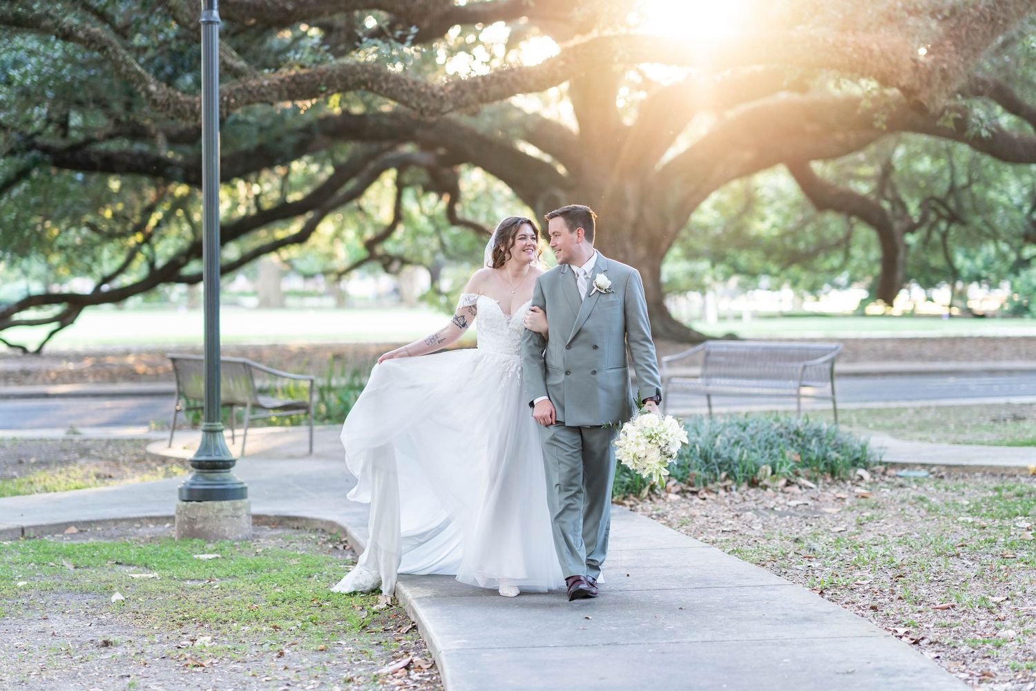 bride and groom walk together near LSU campus