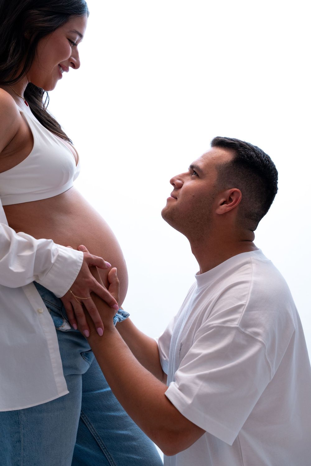 Emotional studio maternity portrait of a couple sharing a quiet moment while celebrating the anticipation of their baby's arrival.