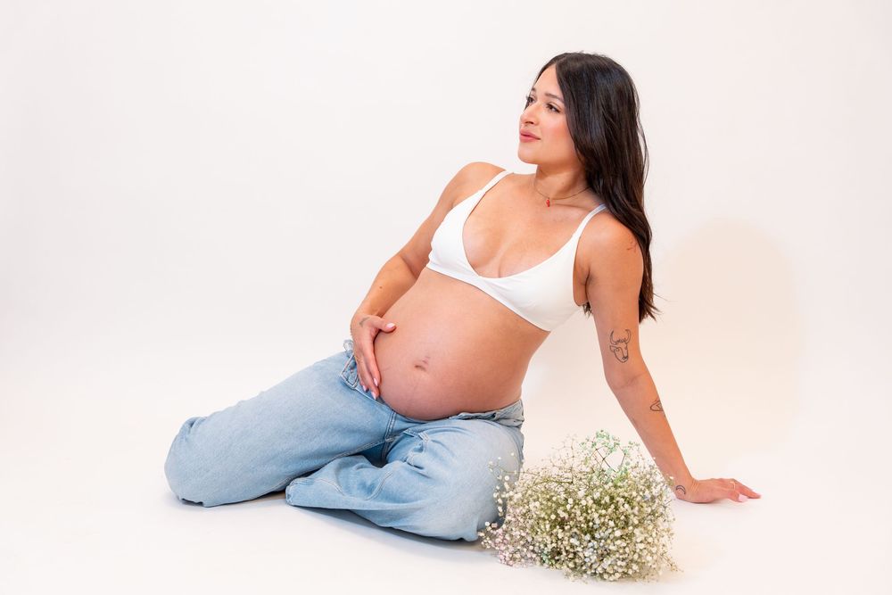 Minimalist studio maternity portraits celebrating pregnancy with soft light, timeless styling, and elegant natural poses.