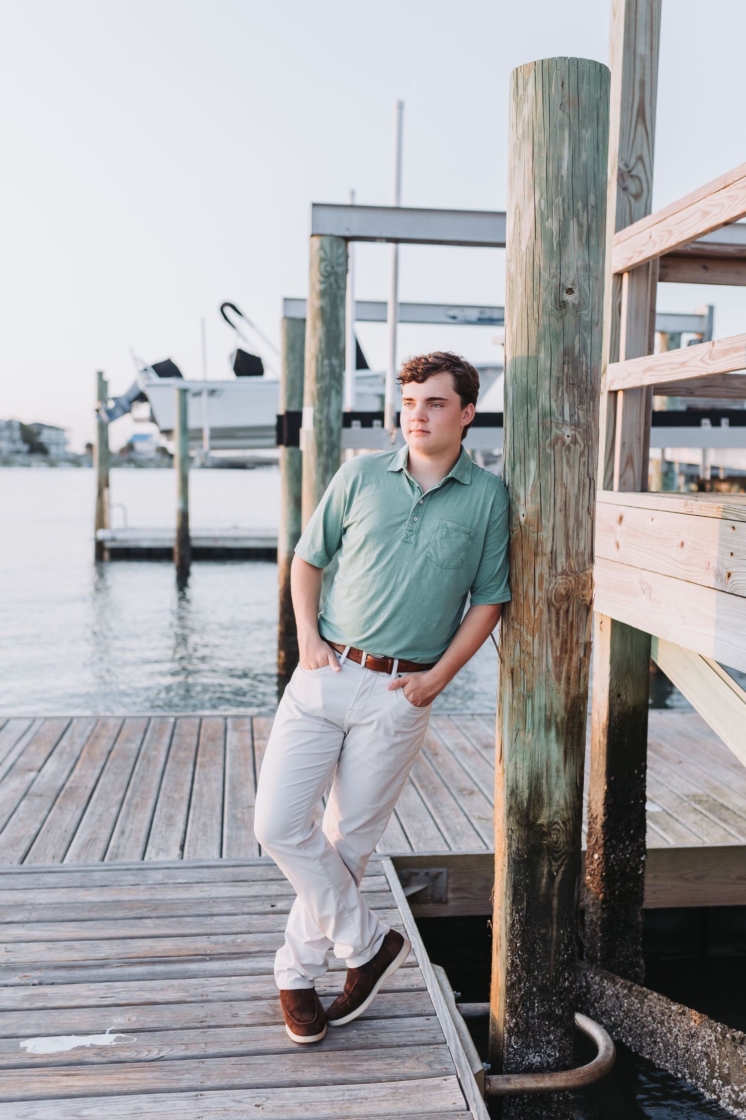 Casual summer look with mint polo and khakis on waterfront dock.