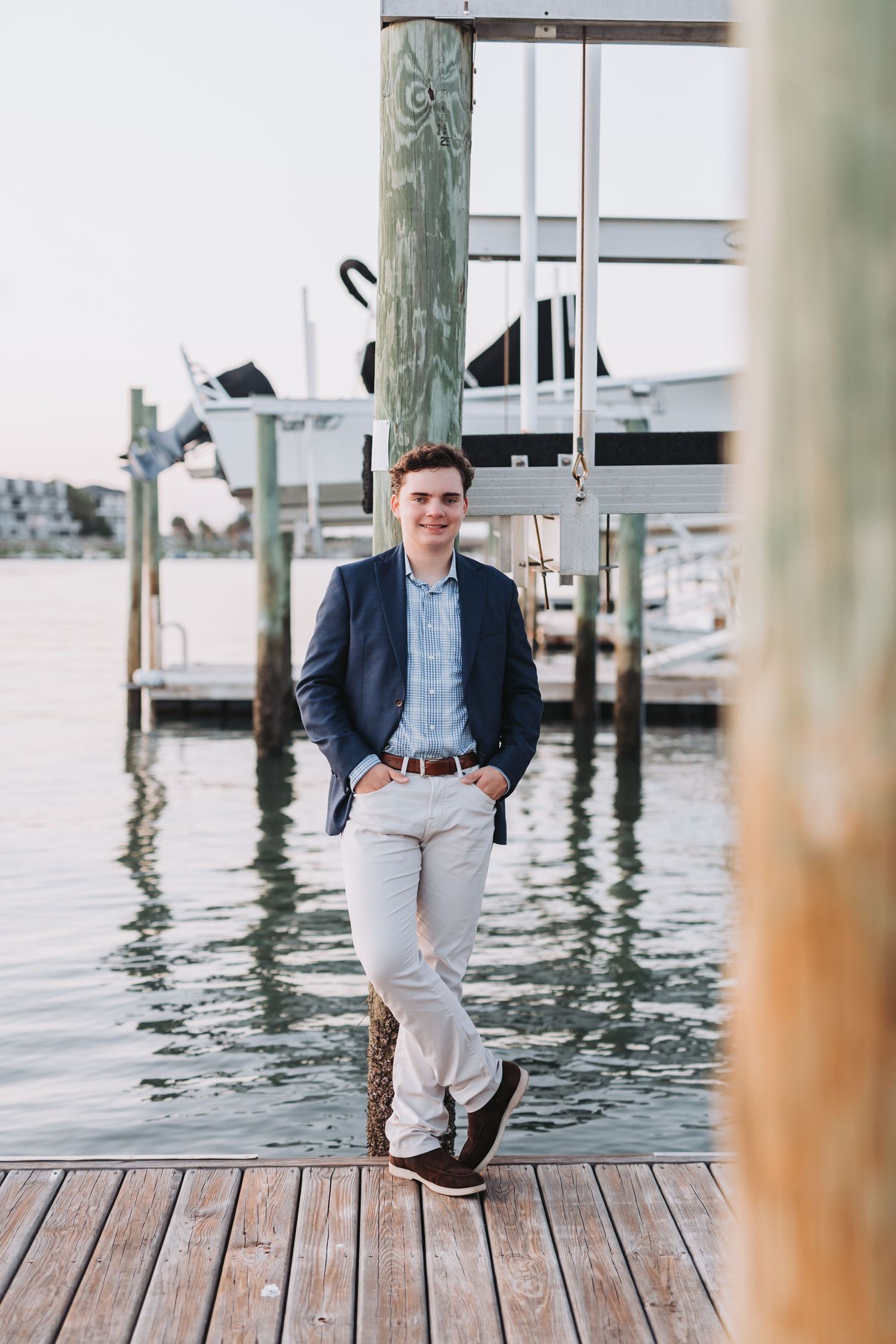 Navy blazer and khaki business casual look on marina dock.
