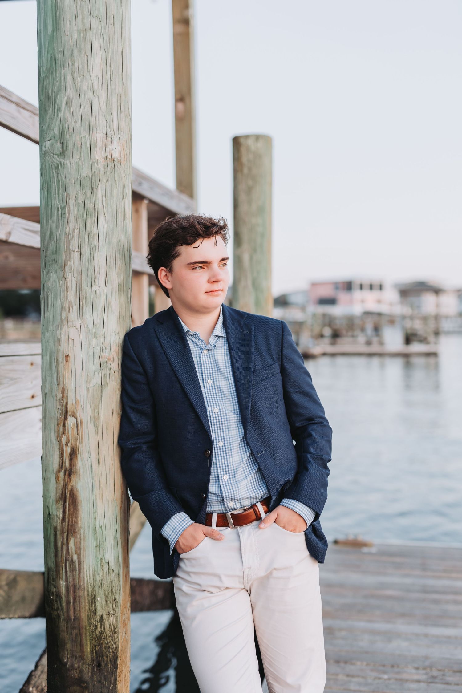 Professional coastal portrait in navy blazer and checkered shirt.