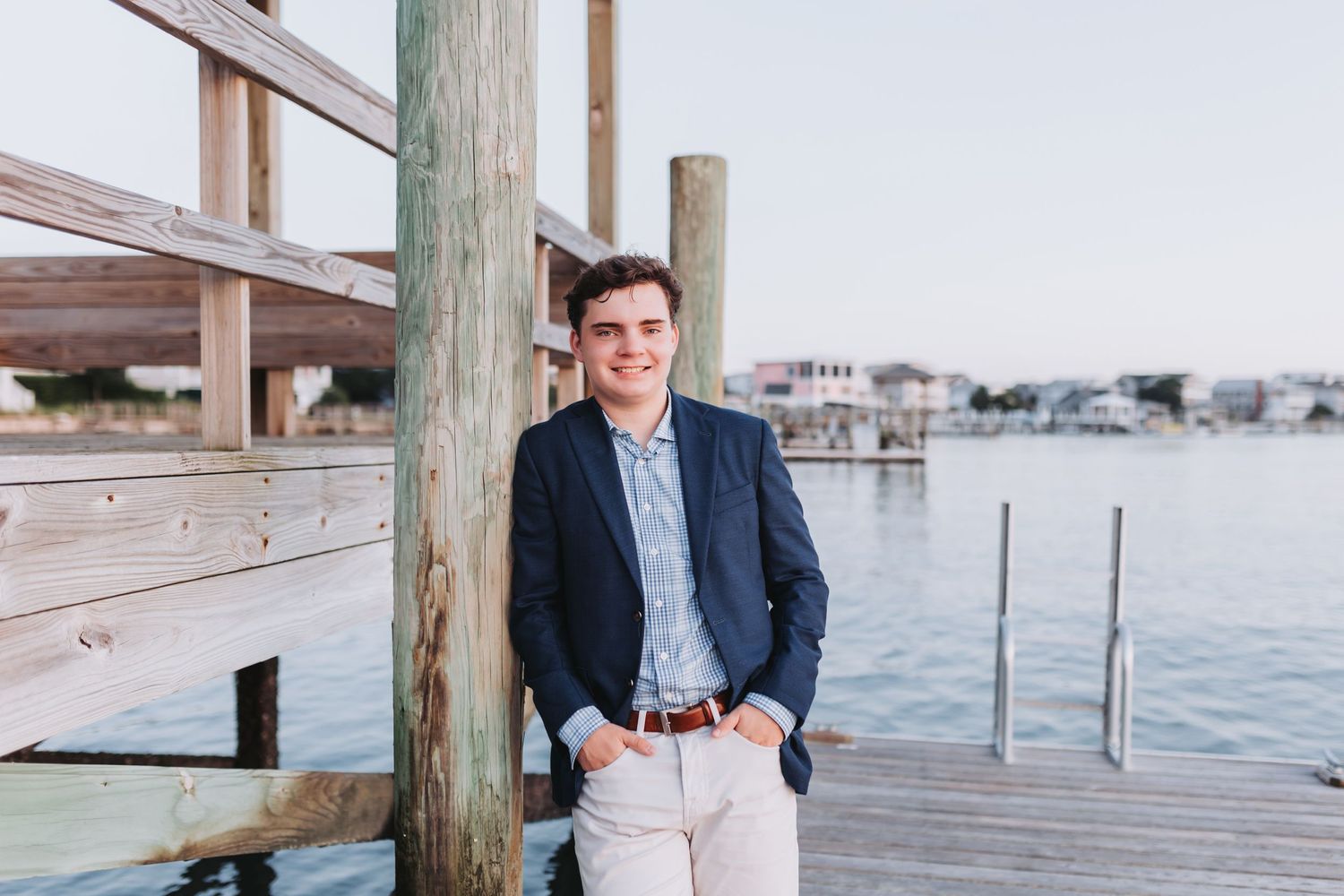 Business casual waterfront photo with navy blazer against marina backdrop.
