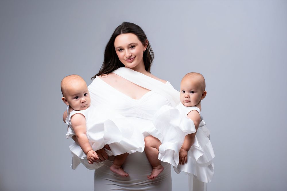 Modern studio milestone photography of mother with twin babies