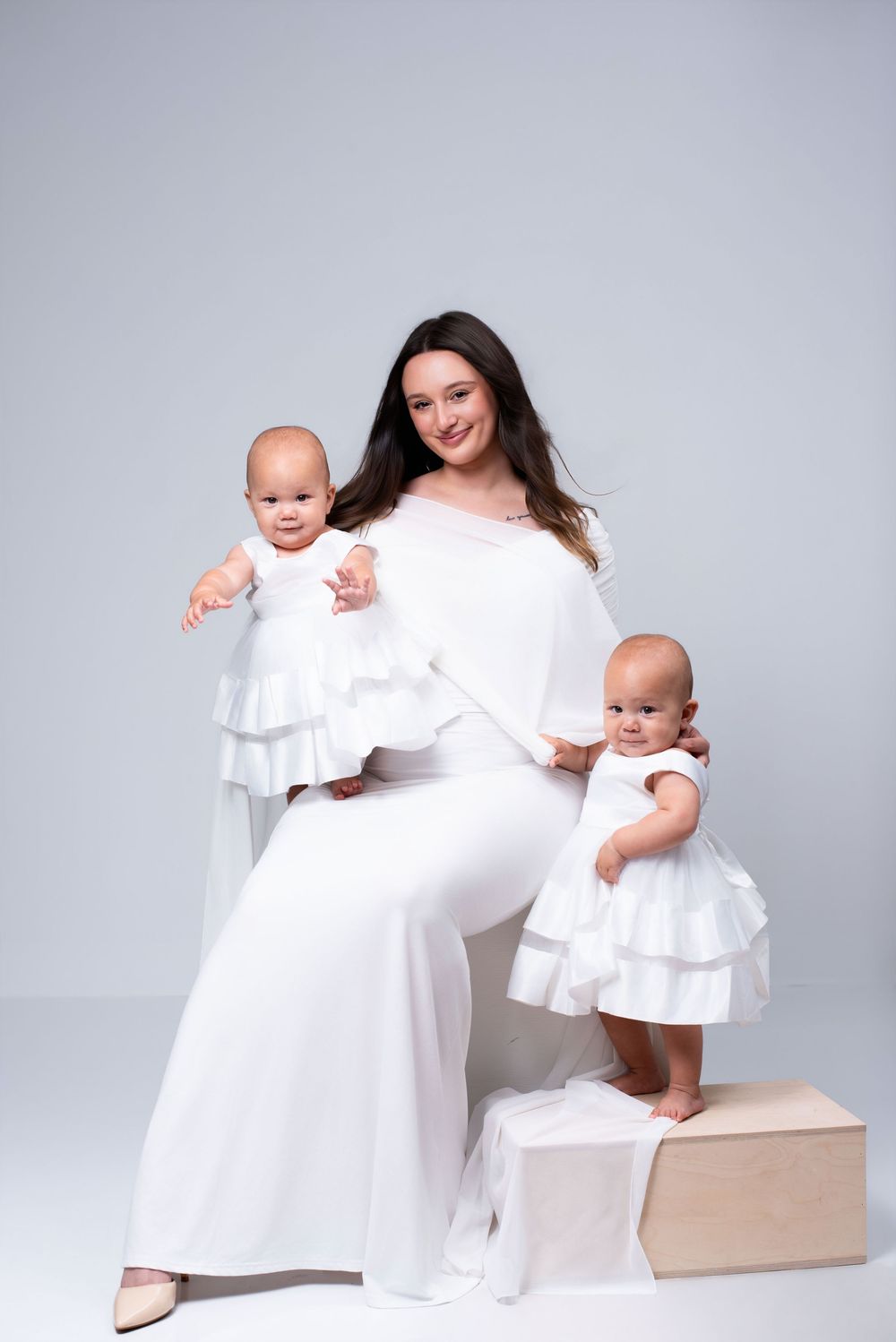 Mother and twin babies portrait in minimalist photography studio