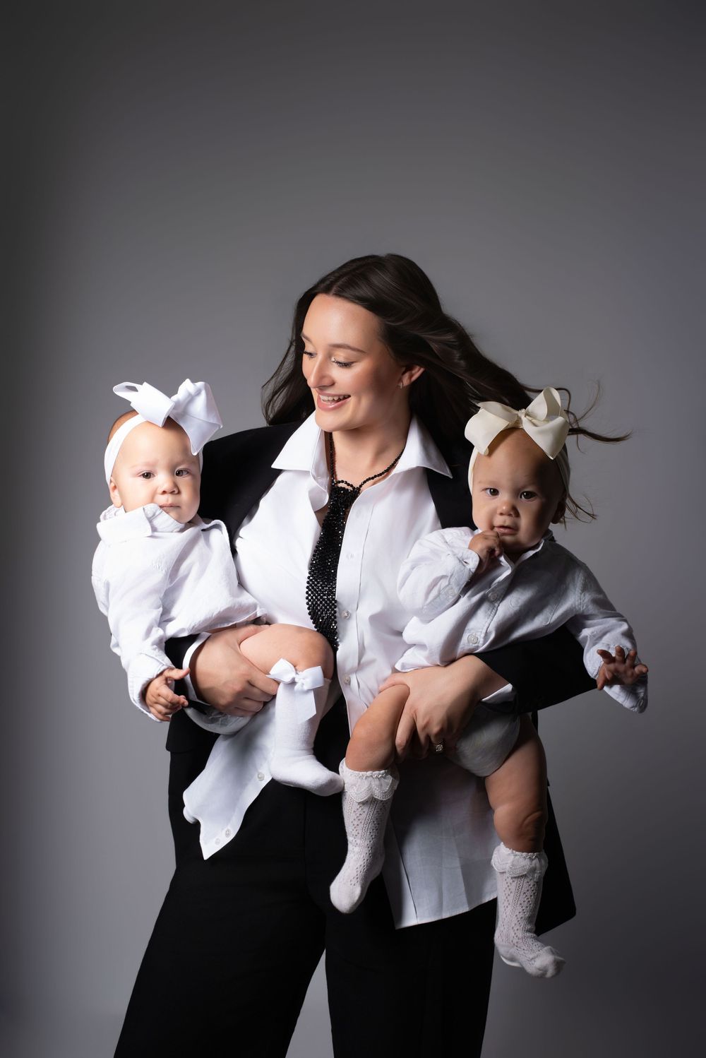 Modern studio milestone photography of mother with twin babies