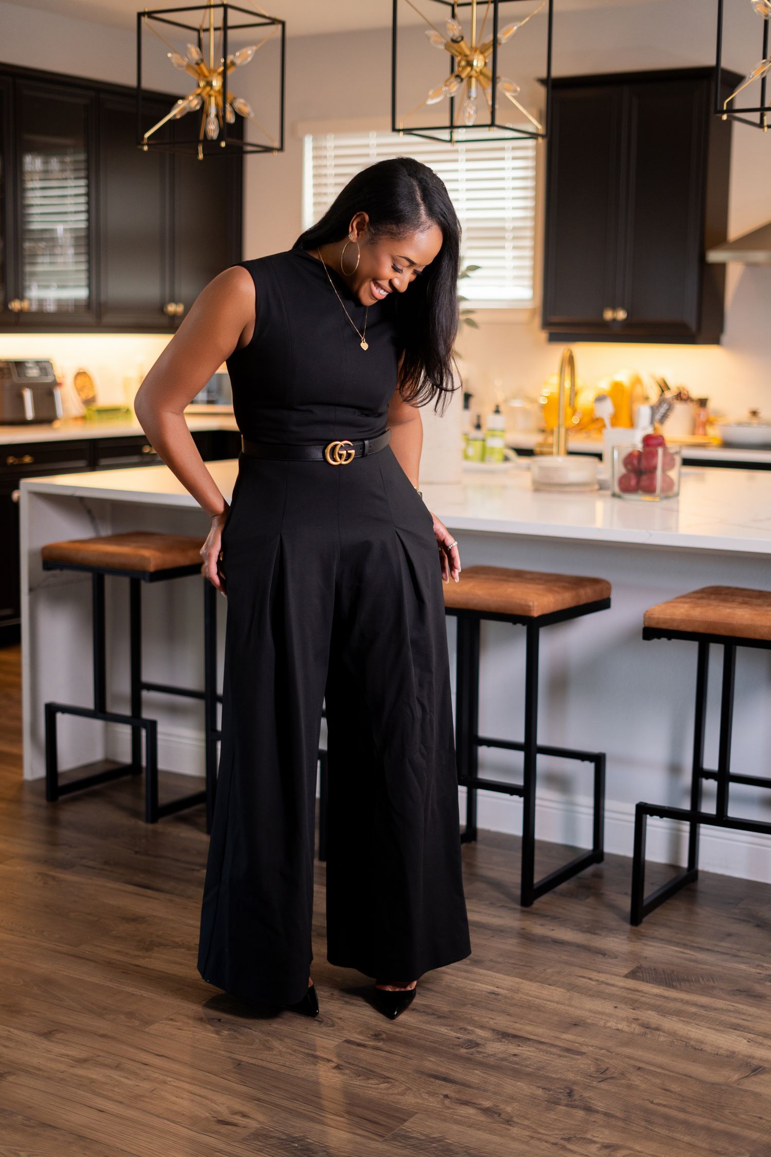 Orlando on location branding photographer Ray Alvarez — interior designer standing in modern dark kitchen during personal branding session