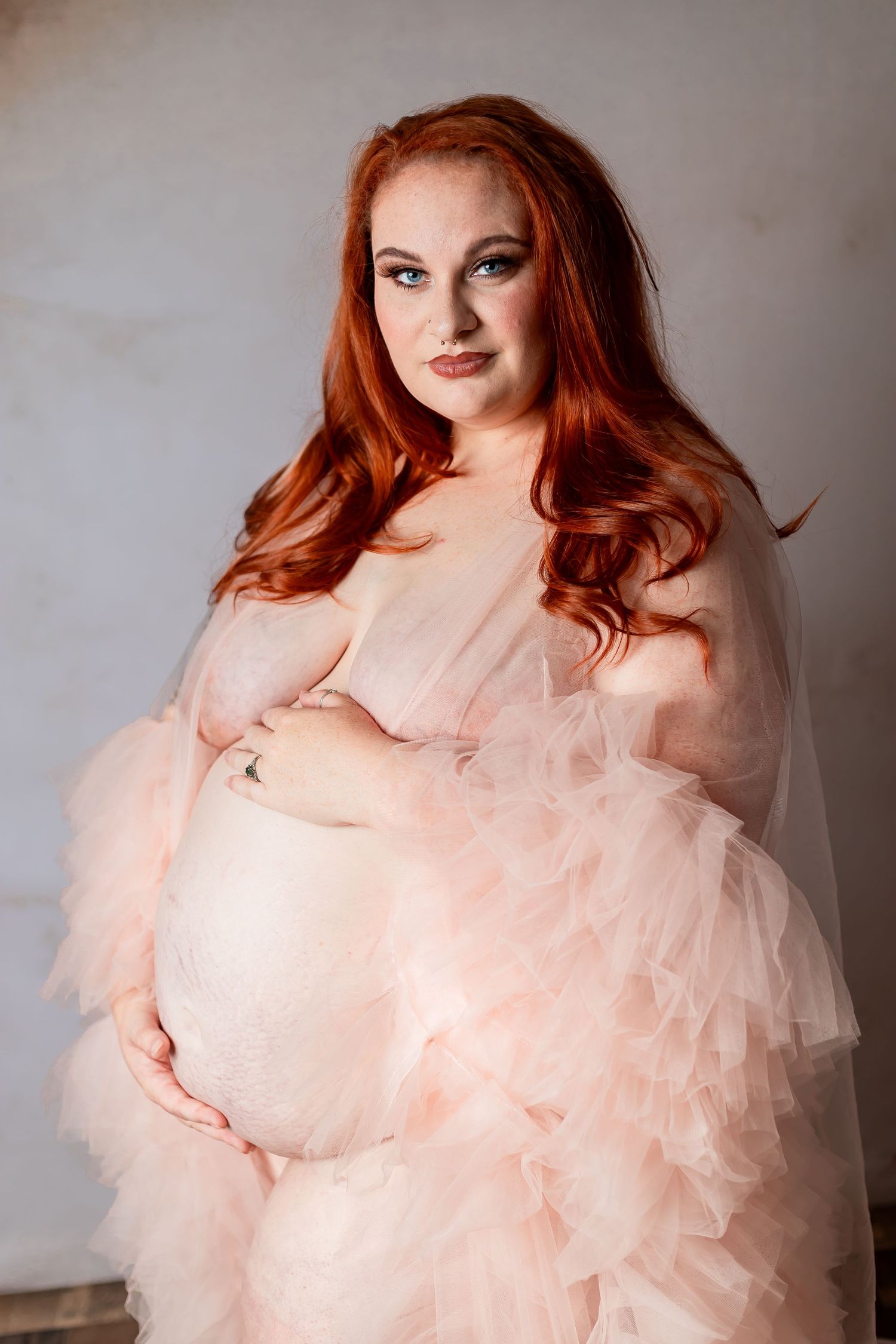 A figure in a flowing pink tulle gown poses gracefully against a neutral backdrop in a series of artistic portraits.