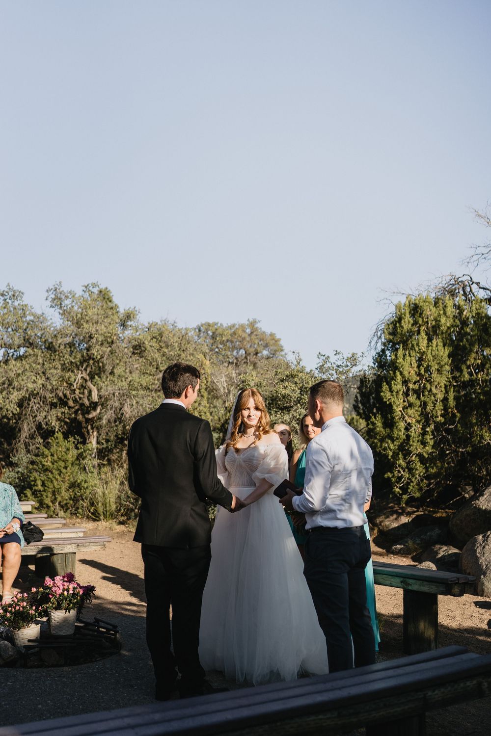 Bride and groom exchange vows with officiant during an intimate outdoor wedding ceremony at Elena Gallegos Trailhead