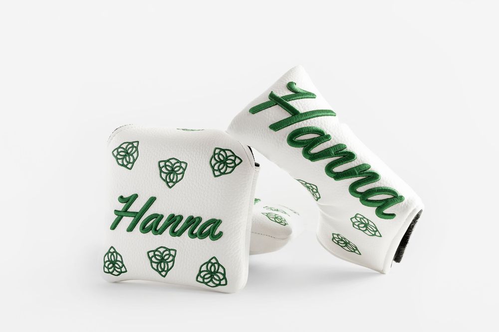 White and green personalized golf putter covers with 'Hanna' script and Celtic knot rose design.