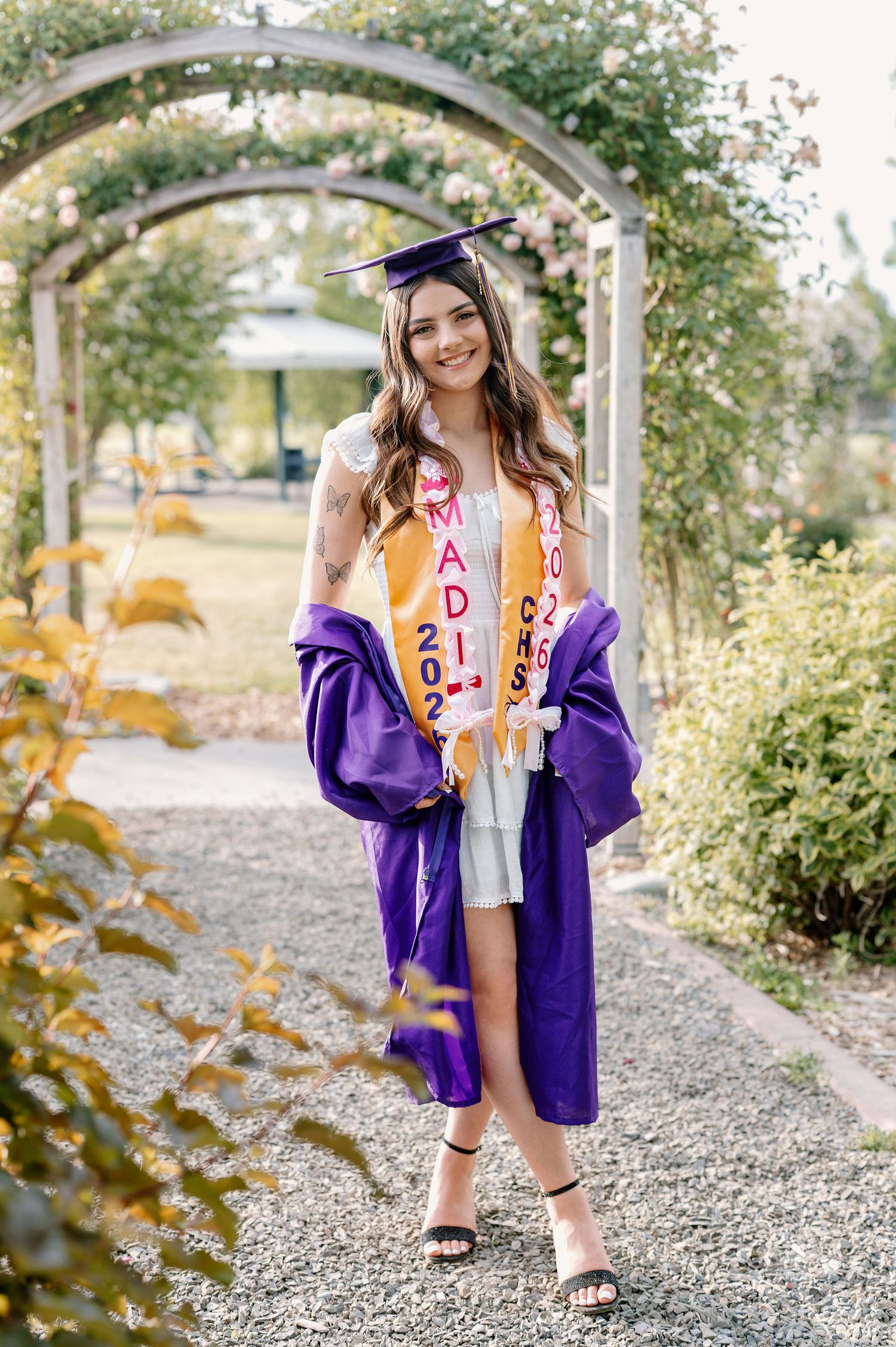 2026 senior with her cap and gown at WSU Demonstration Gardens in Tri-Cities, WA