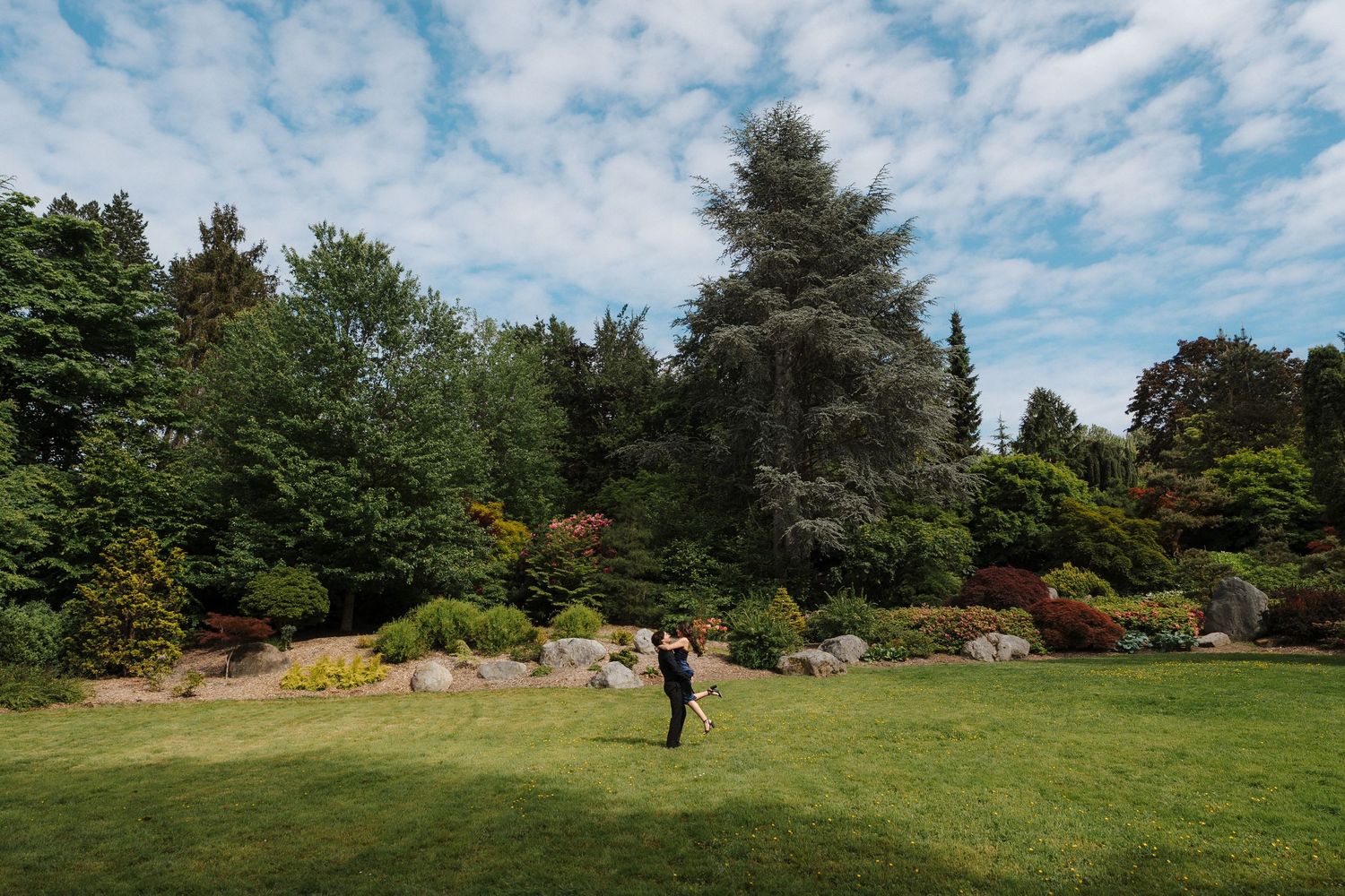 Blake spins Gabriella after their proposal at Kubota Gardens in Seattle