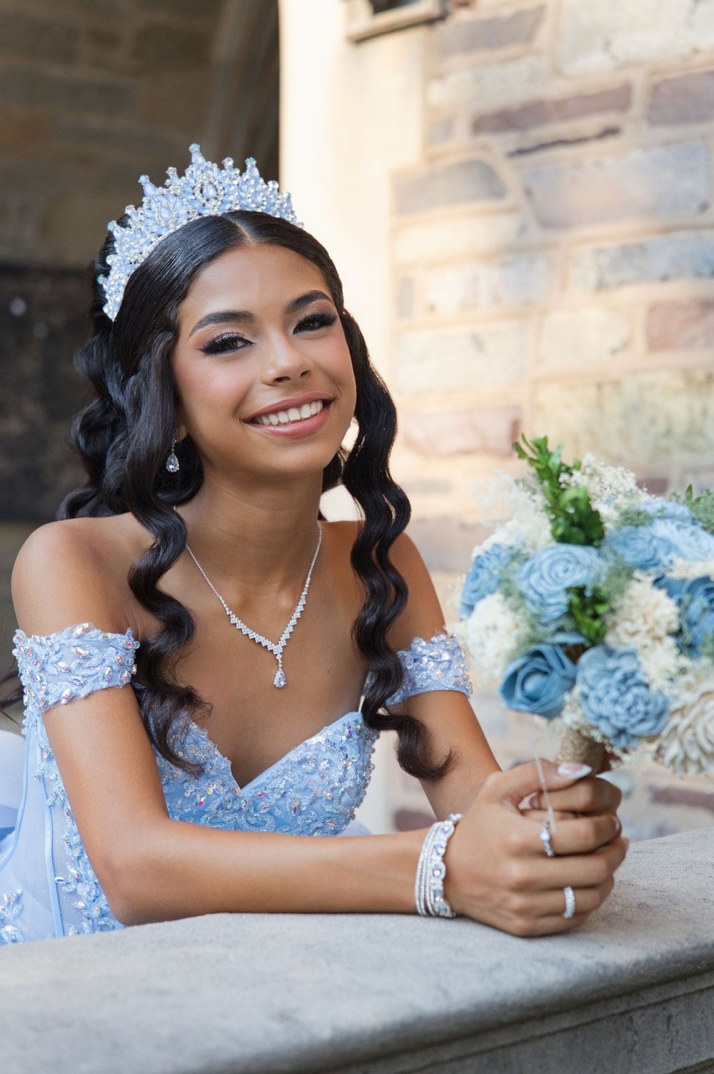 Quinceañera in a blue gown and tiara holding a bouquet, New Jersey milestone portrait photography