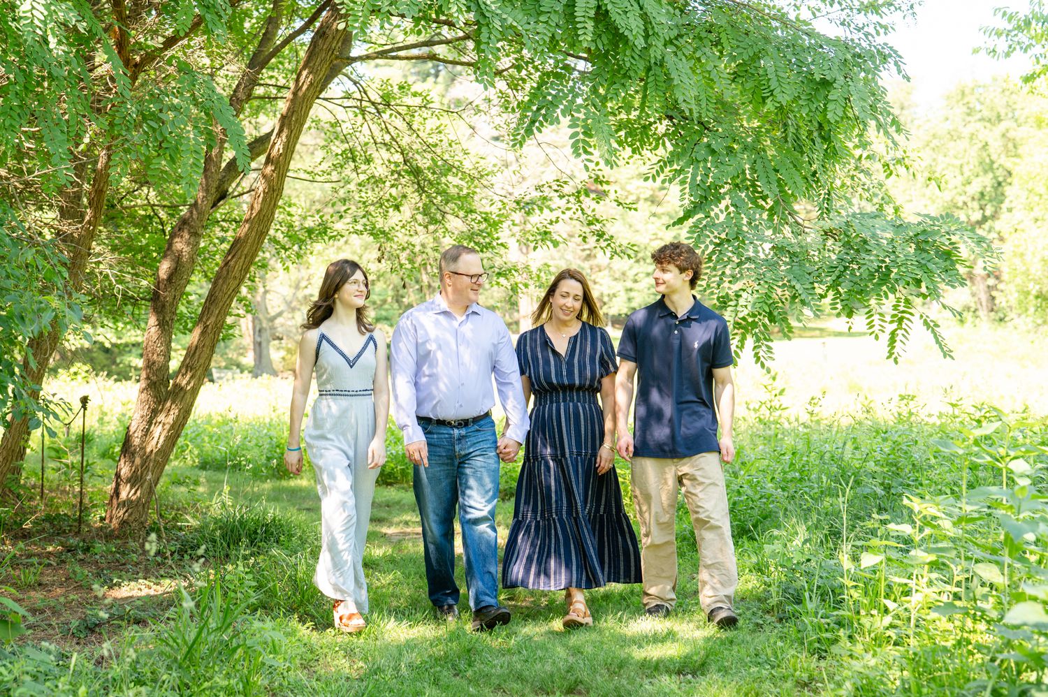 Family laughing together during an outdoor family photo session in Arlington, VA