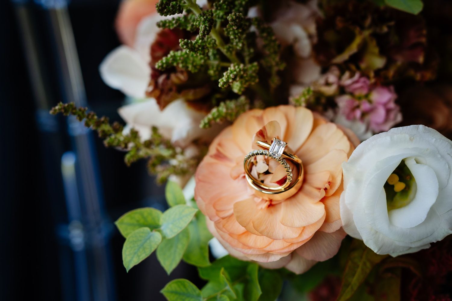 Wedding rings on peach and white bouquet, Azuridge wedding in Priddis