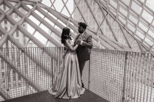 Black and white photo of a couple in the Seattle Library in wedding attire, Captured by Savvy Photography
