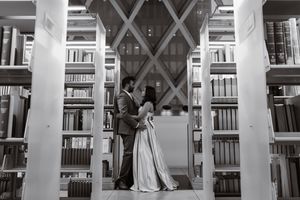 Black and white photo of a couple in the Seattle Library in wedding attire, Captured by Savvy Photography