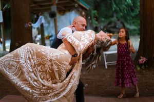 Couple during their first dance, in a dip, during a backyard wedding reception, Captured by Savvy Photography