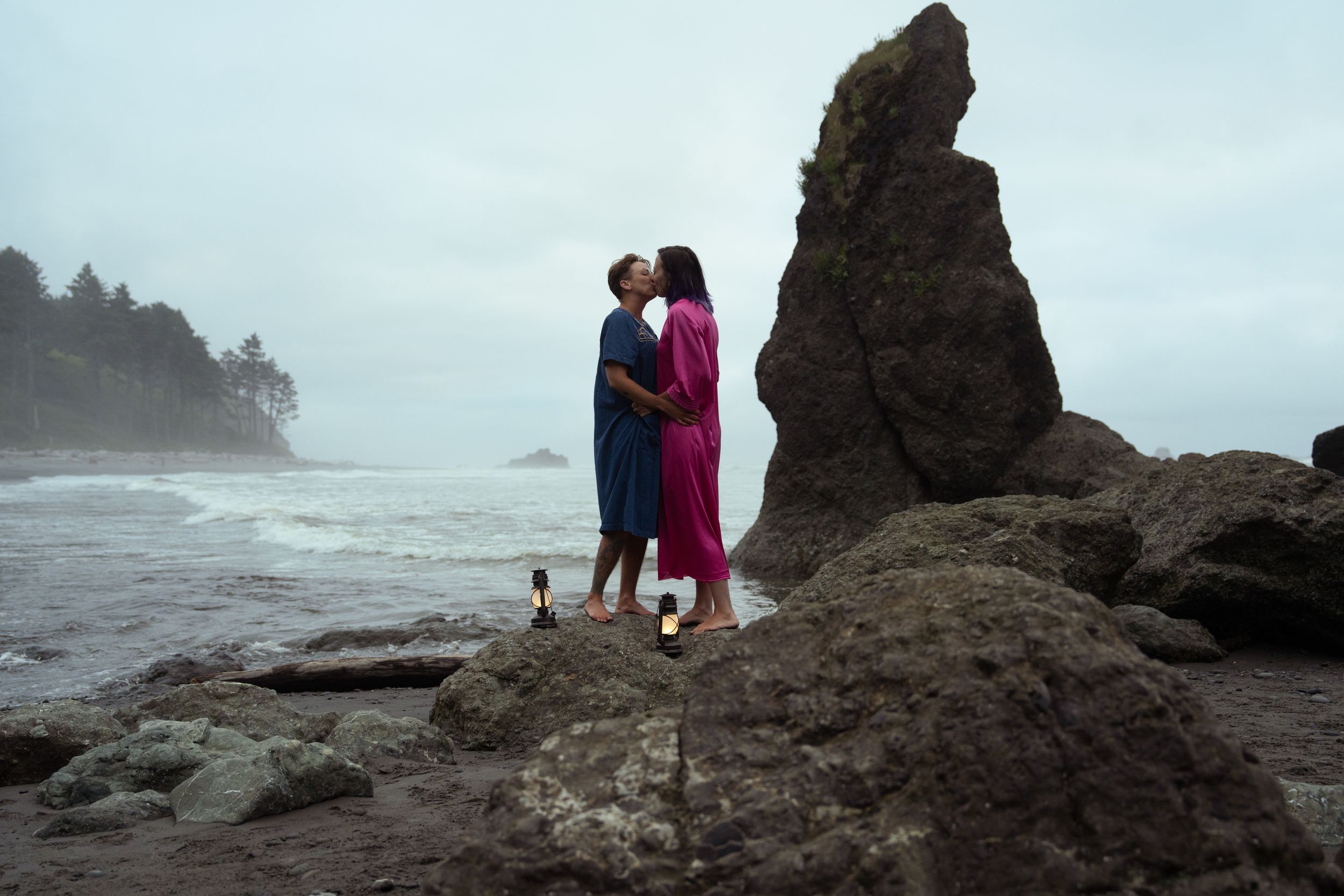 Couple kissing on rocky beach with dramatic sea stacks in Olympic National Park, Captured by Savvy Photography