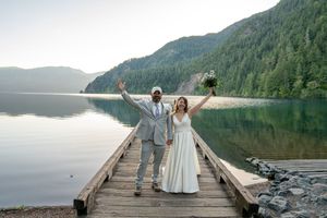 Joyful newlyweds celebrate on a wooden in Olympic National Park, Captured by Savvy Photography