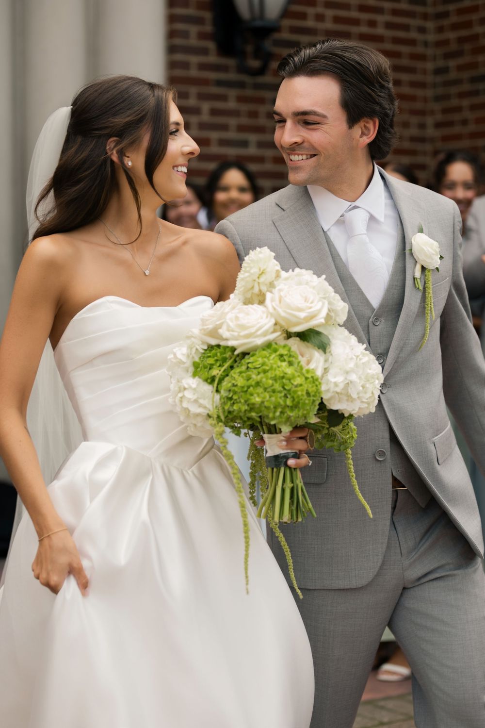 Bride and groom just married leaving their ceremon at St. Luke the Evangelist Church in Lakewood, Ohio